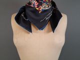 a close up of a mannequin torso with a scarf on it