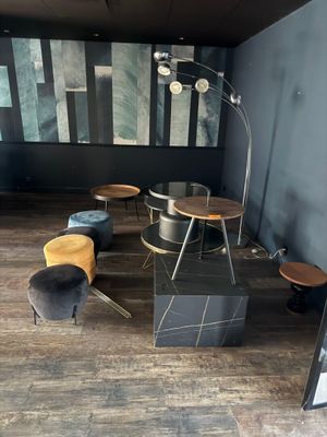 a room with a table, chairs, and a picture on the wall