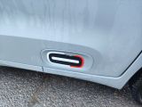 a close up of a car door handle with a red button on it