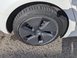 a white car that has a flat tire on it