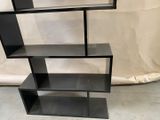 an image of a black bookcase with three shelves