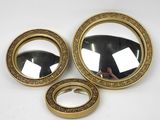 two mirrors and a ring are sitting on a white surface