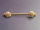 an image of a gold nose piercing with pearls on it