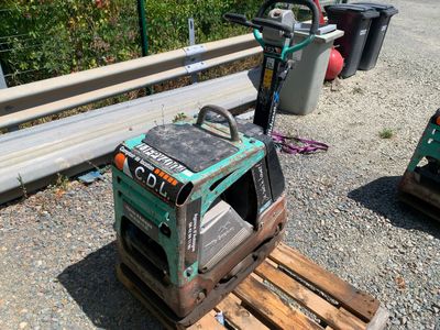 a forklift that is sitting on a pallet in the dirt
