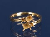 une bague en or ornée d'une tortue sur un fond bleu