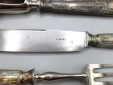 three different types of knives and a fork on a table