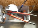 a container with tools in it sitting on a table