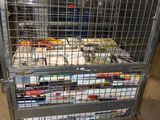 a large metal cage with a bunch of books on it