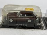 a toy car in a plastic case on a white surface