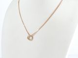 a gold necklace with a circle pendant on a mannequin neck