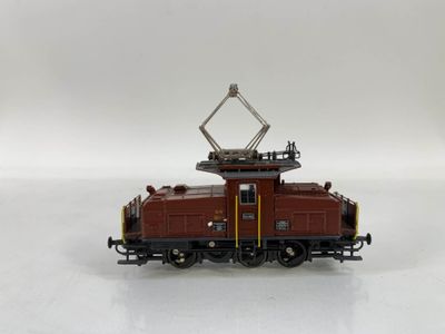 un petit train sur une surface blanche avec un fond blanc