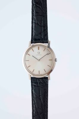a close up of a watch on a black leather strap