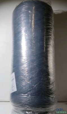 a roll of blue yarn wrapped in plastic on a shelf