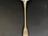 a close up of a spoon on a table with a black background