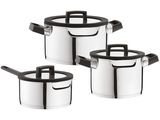 three stainless steel pots with lids and spoons on a white background