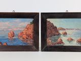 two framed paintings of a rocky coast and a body of water