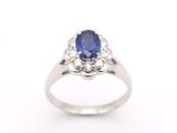 an oval sapphire and diamond ring on a white background
