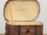 an old suitcase with a wooden handle sitting on top of a table