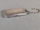 a silver purse with a chain attached to it