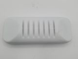 a close up of a white plastic comb on a table
