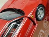 a close up of a red toy car on a table
