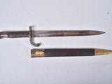 two different types of knives on a white surface