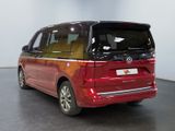 the red volkswagen minivan is parked in a showroom