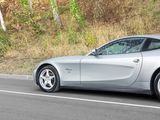 a silver sports car driving down the road