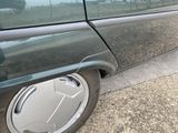 a picture of a car with a flat tire on the side of the road