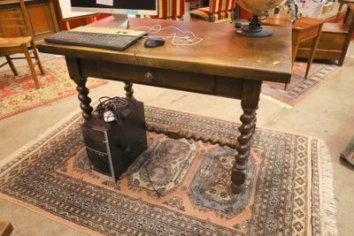 a desk with a computer on it and a lamp on top of it