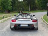a silver sports car driving down the road