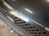 a close up of a car ' s grille and the front end of it