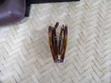 a pair of hair clips on the floor next to a pair of shoes