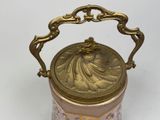 a gold and pink vase with a handle on it