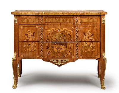 a wooden chest of drawers with carvings on it
