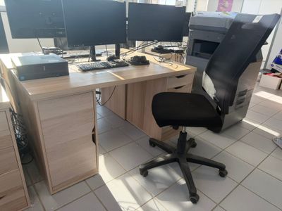 a computer desk with two monitors and a keyboard
