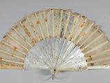 a white fan that is hanging on a wall