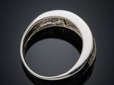 a close up of a silver ring on a black surface