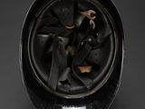 a close up of a black vase on a table