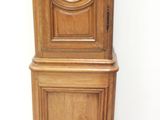 a wooden grandfather clock with a round window on the top of it