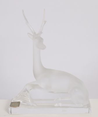an image of a glass sculpture of a deer on a table