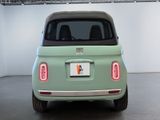 an image of a small green car parked in a garage