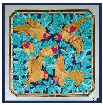 une photo d'une broderie au point de croix représentant des oiseaux et des feuilles