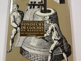 the cover of a book with a drawing of two men working on a large bell
