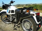 a motorcycle that is parked on a gravel road