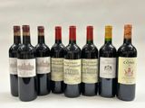 six bottles of wine are lined up on a white surface