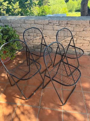 three chairs that are sitting on a patio