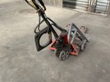 an image of a small hand held lawn mower in a garage