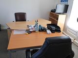 a desk with a chair and a phone on top of it