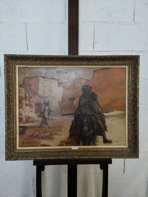 un tableau représentant un homme à cheval dans le désert